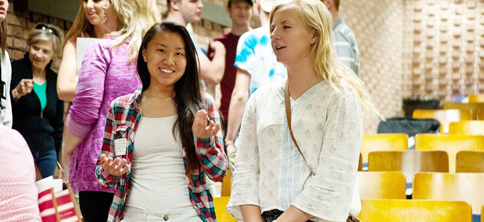 Two female students smiling at orientation